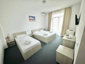 Postel nebo postele na pokoji v ubytování Neptun Resort + 24 fotografií