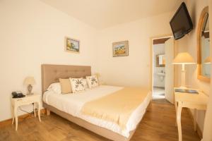 Postel nebo postele na pokoji v ubytování Hotel la Caravelle