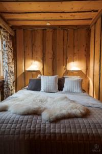1 cama en una habitación con 2 lámparas en la pared en Villa Kelo by Hilla Villas, en Kittilä