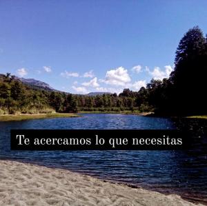 a lake with the words t accamens io give necessities at Santos Lugares Cabañas in Junín de los Andes