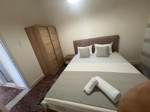 a small bedroom with a bed with two pillows at SMYRNA HOMES CHiOS ERATO in Chios