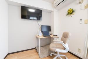 a room with a desk with a computer and a chair at Sakura Serenity House Komagome in Tokyo