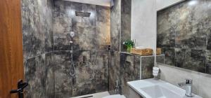 a bathroom with a shower and a sink at Ika Delux in Burgas +21 photos