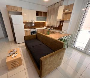a living room with a couch and a kitchen at 4 seasons apartment 102 eco in Thiva