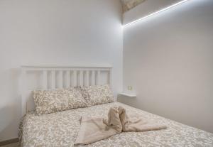 a bedroom with a bed with a pillow on it at Casa Terra Antica Timeless Apulian Charm in Ceglie Messapica +4 photos