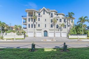a large white house with palm trees in front of it at Admirals Watch - 673 in Siesta Key