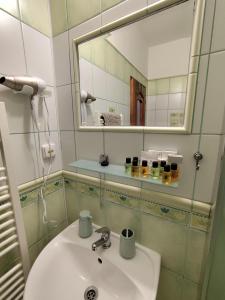 a bathroom with a sink and a mirror at Penzion Mystery in Vyšné Ružbachy +21 photos
