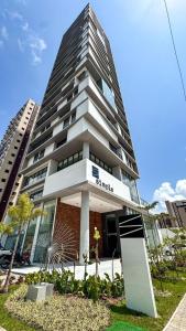 a tall building with a sign in front of it at Studio306 - Simple 350 in João Pessoa