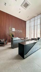 a lobby with two reception desks in a building at Studio306 - Simple 350 in João Pessoa +8 photos