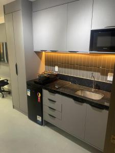 a kitchen with a sink and a counter top at Studio306 - Simple 350 in João Pessoa