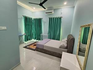 a bedroom with a bed and a mirror at Aura Beach Homestay in Kampong Ru Sepuloh