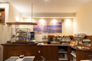 a kitchen with a counter with food on it at Hotel Angelica Firenze in Florence
