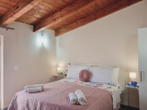a bedroom with a bed with two white shoes on it at Il Sogno di Ulisse in Le Castella