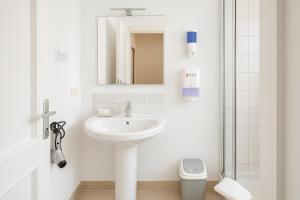 a white bathroom with a sink and a toilet at Roma Talenti Breme B&B in Rome +39 photos