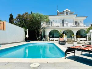 a swimming pool in front of a house at Global Immo 8010 Montclar in Roses
