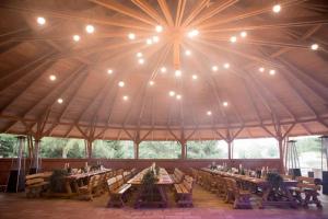 a large tent with tables and chairs in it at Hotel Trzy Podkowy in Biskupiec