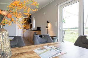 a living room with a table and chairs at Chalet Rustique in Oldeberkoop