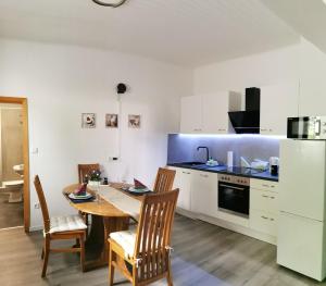 a kitchen with a table and chairs in a room at Diemeltal Lodge Appartment III in Marsberg