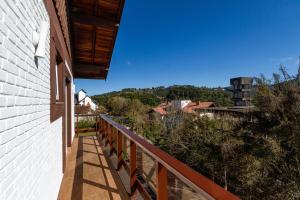 a balcony with a view of a city at Hotel Chateau in Campos do Jordão