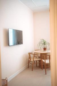 a dining room with a table and a tv on the wall at Borgo Pio Suite Apartment in Rome
