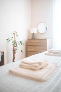 a white bedroom with a bed with a mirror at Borgo Pio Suite Apartment in Rome
