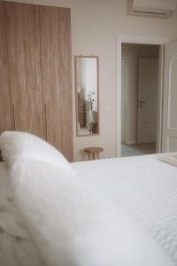 a bedroom with a white bed and a mirror at Borgo Pio Suite Apartment in Rome