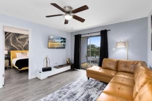 a living room with a couch and a bed at Oasis 316 - Palm Paradise in Titusville