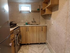 a kitchen with a sink and a washing machine at Квартира in Ganja +9 photos