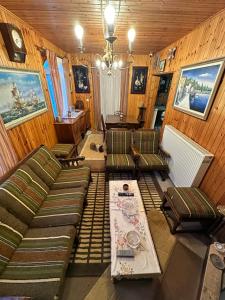 a living room with couches and a table at Villa Ikaros Ag Apostoloi Attica in Mesochórion