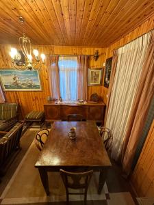 a dining room with a table and a couch at Villa Ikaros Ag Apostoloi Attica in Mesochórion