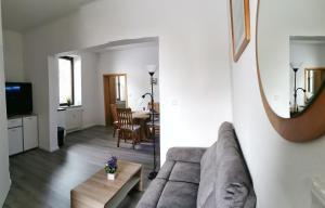 a living room with a couch and a table at Diemeltal Lodge Appartment III in Marsberg