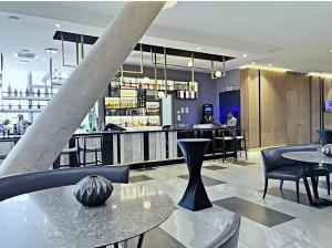 a restaurant with tables and chairs and a bar at Stunning City View Apartment Sandton City in Johannesburg