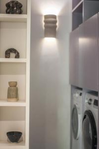a kitchen with a refrigerator and a washer and dryer at Beautiful duplex apartment in a farmhouse in Provence Verte VAR in Bras