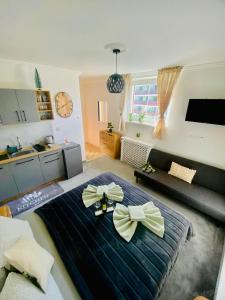 a room with a large bed with bows on it at Apartmán DEJA VÚ - Tatranská Štrba in Štrba +31 photos