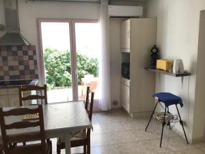 kuchnia ze stołem i kuchnia z oknem w obiekcie Appartement avec extérieur et parking gratuit w Perpignanie +8 zdjęć