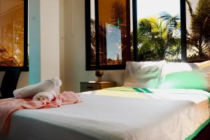 a bedroom with a bed with a towel on it at Cielo Blue Hotel Boutique in El Peñol