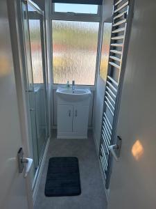 a bathroom with a sink and a window at Charming 2 Storey Holiday Villa in Dawlish Warren in Dawlish Warren