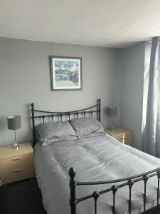 a bedroom with a large bed with two night stands at Charming 2 Storey Holiday Villa in Dawlish Warren in Dawlish Warren