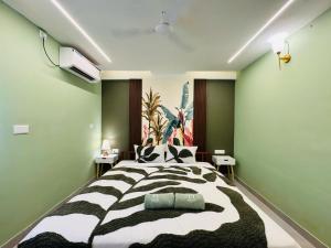a bedroom with a large black and white bed at Alcove Stays in Bengaluru +3 photos