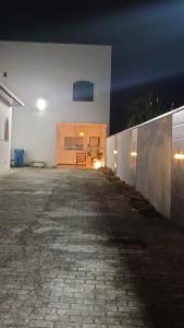 an empty building with a brick walkway at night at Cantinho da LAGO in Itacuruçá