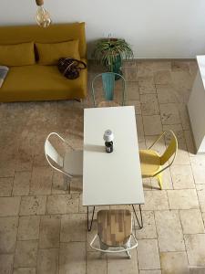 a living room with a white table and chairs at Casa Camelia - Elegant Palace with Terrace - Conversano in Conversano