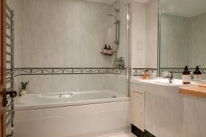 a white bathroom with a tub and a sink at Deanshaugh - Seasgair Lodges in Deanshaugh +25 photos