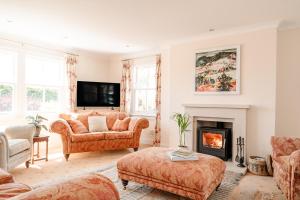 a living room with a couch and a fireplace at Deanshaugh - Seasgair Lodges in Deanshaugh