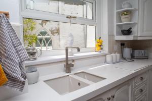 a kitchen with a sink and a window at Sea Salt Tenby in Tenby +34 photos