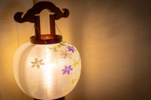a lamp with a flower design on it at HABi-Wakaura in Wakayama