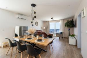a dining room and living room with a table and chairs at Villa Leona in Dubrovnik
