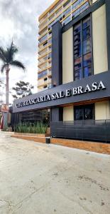 a building with a sign that reads guilgrimannisaleale brasas at Sofisticado Flat em Brasília-BR in Brasilia +79 photos