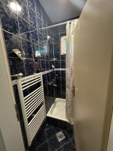 a black tiled bathroom with a shower and a tub at Holiday house Sarajevo  +30 photos