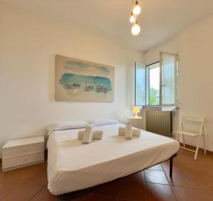 a bedroom with a large white bed in a room at Dimora Concept - Ca' du Dria - Sea and nature - Free parking in Pietra Ligure