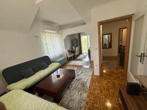 a living room with a couch and a coffee table at Holiday house Sarajevo 